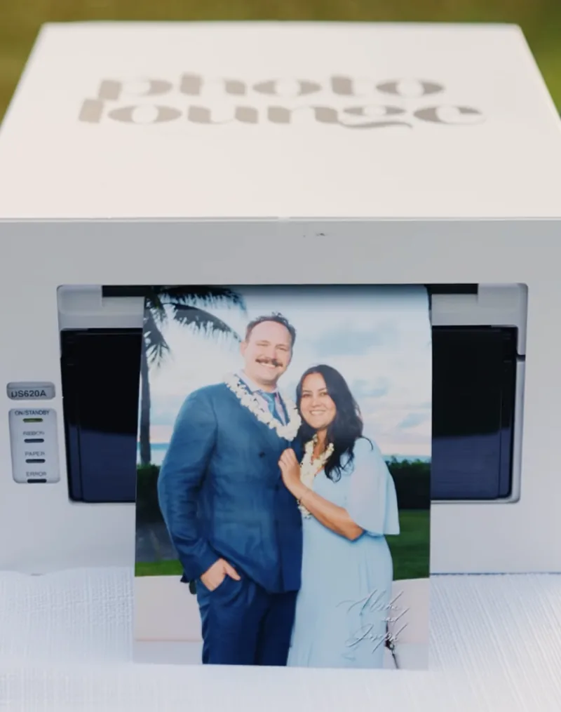 A 5x7 print coming out of the Photo Lounge printer on-site